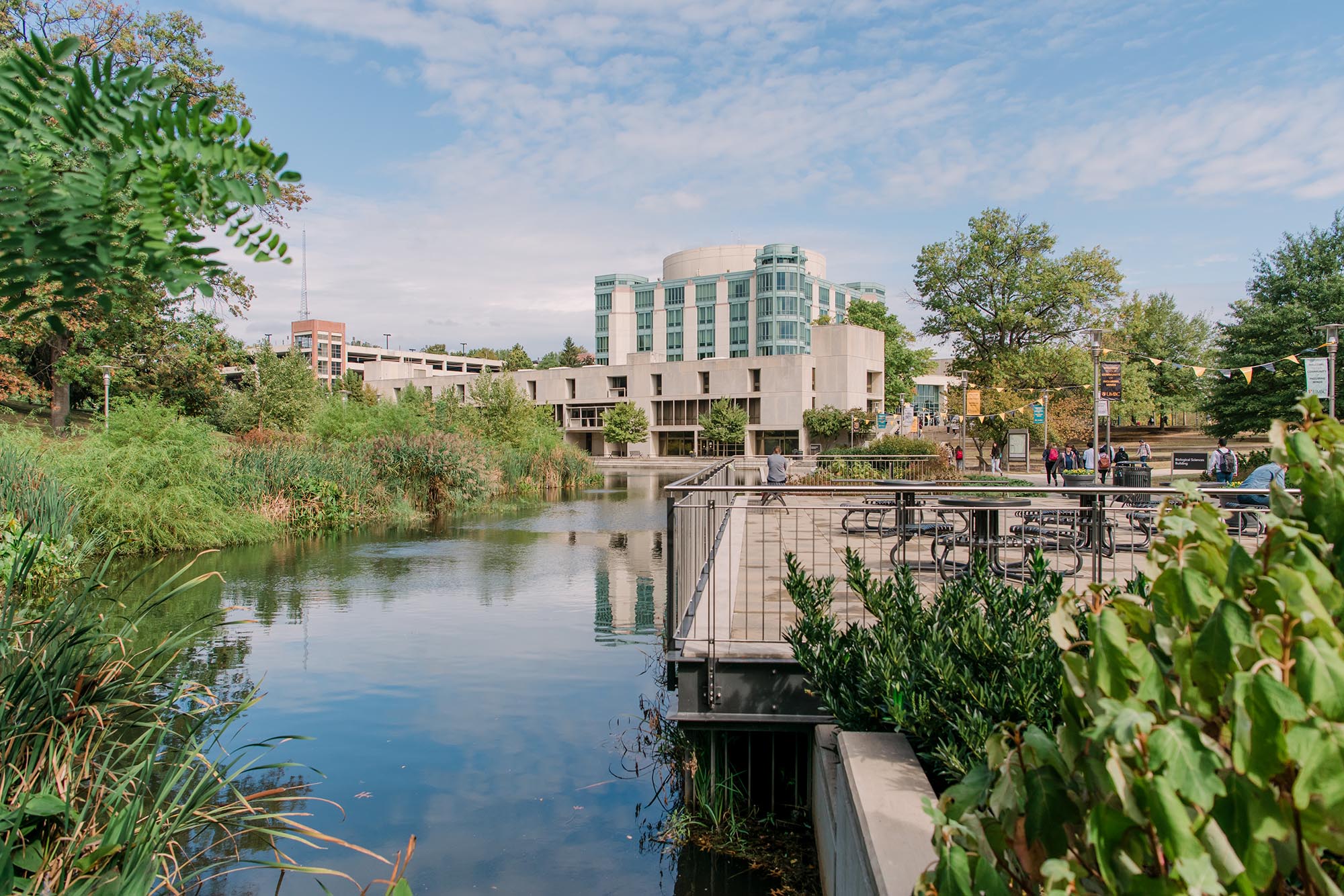 UMBC's campus in the fall, featuring the Library and pond.