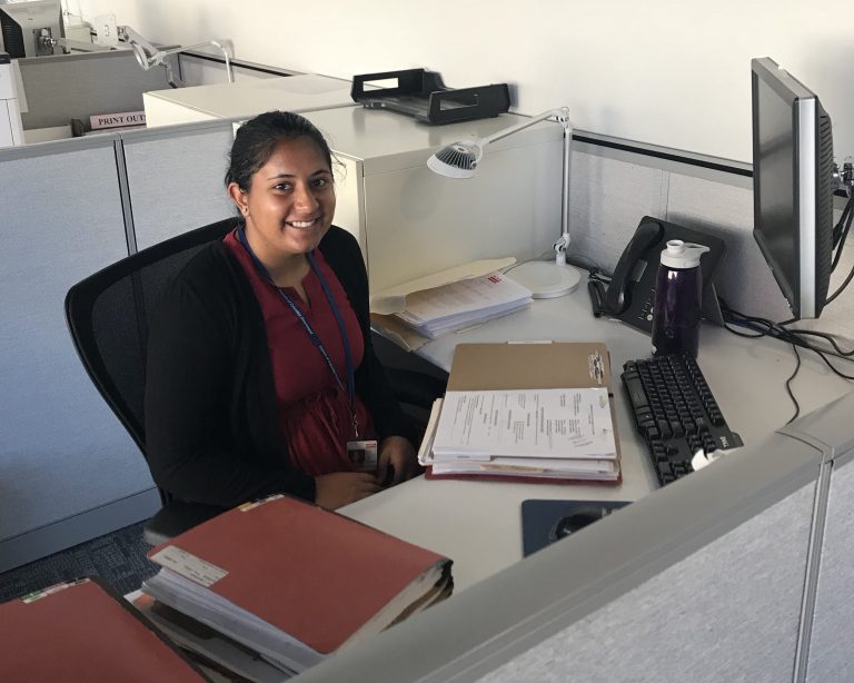 Samiksha working at an office desk.