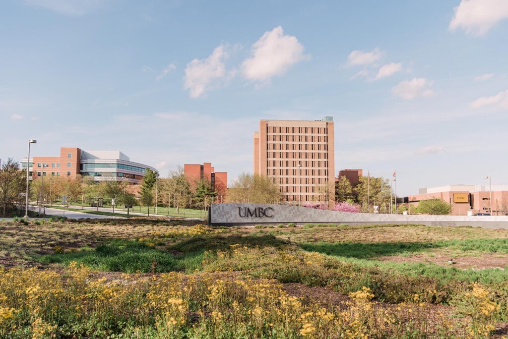 UMBC's campus, featuring the administration building and UMBC sign, on a nice Spring day.