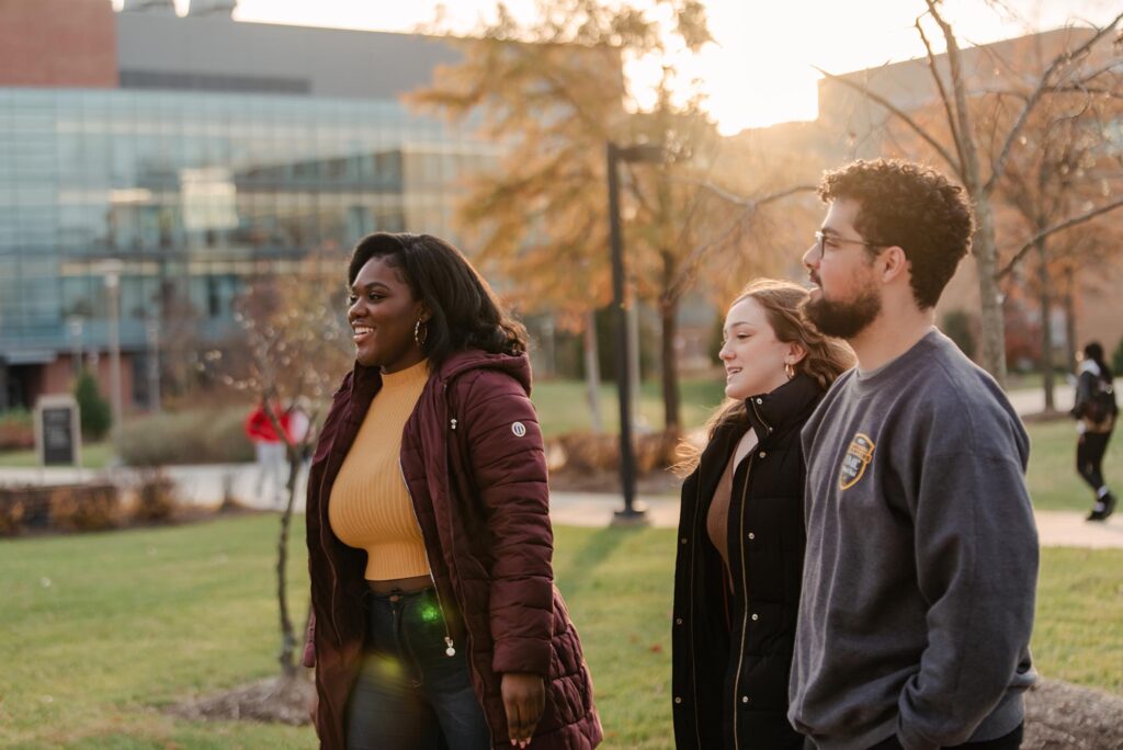 A diverse group of students walking along campus.