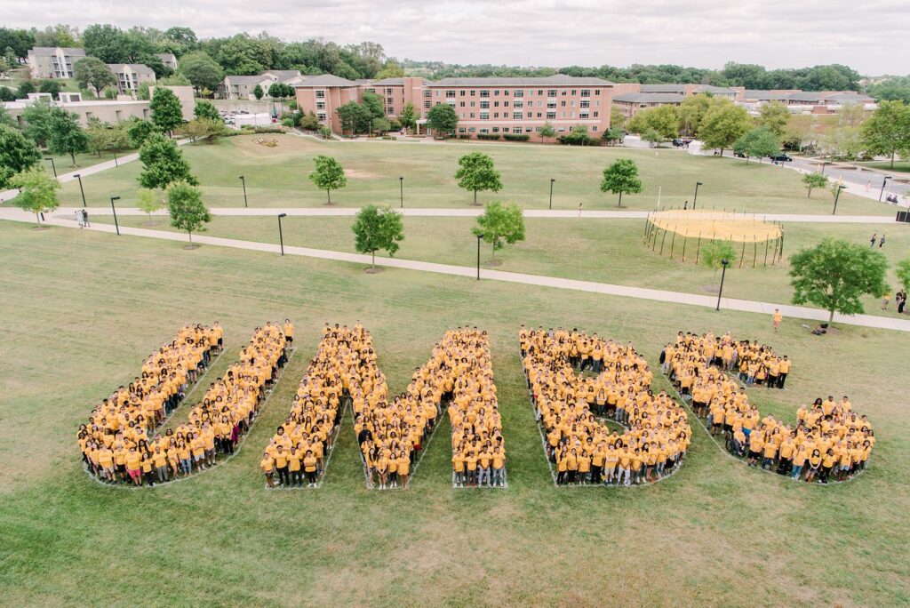A crowd of students forming the letters UMBC.