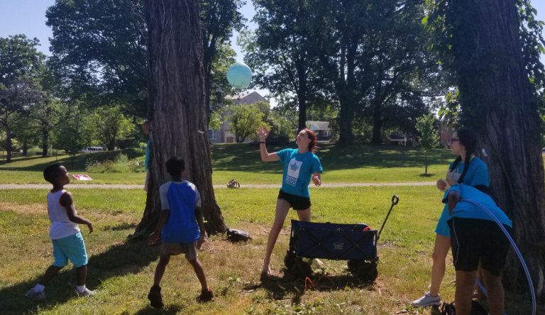 Emily Chetelat playing with kids outside.