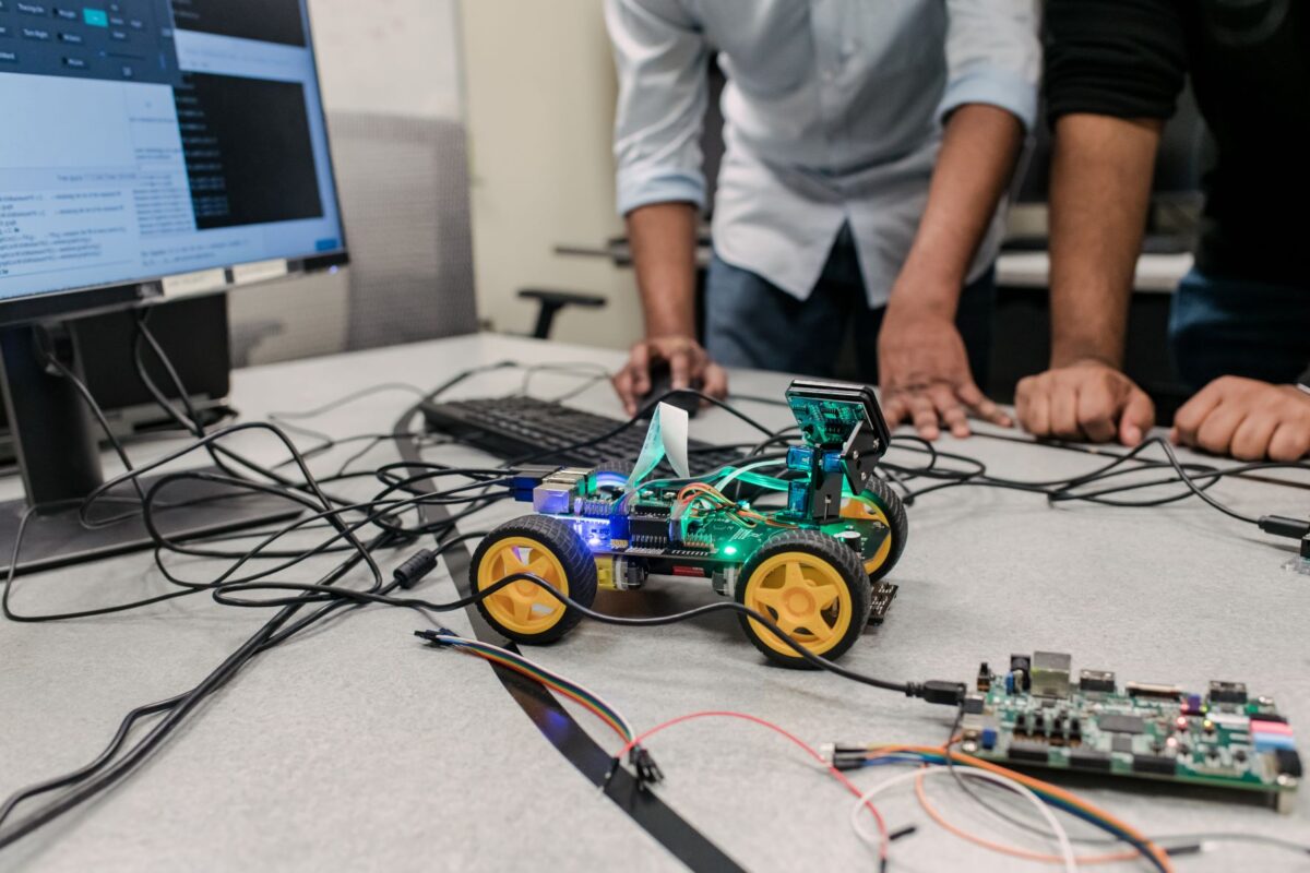 Surrounded by wires and a computer chip, the model vehicle that Islam and his team are using in their research glows with green and blue lights.