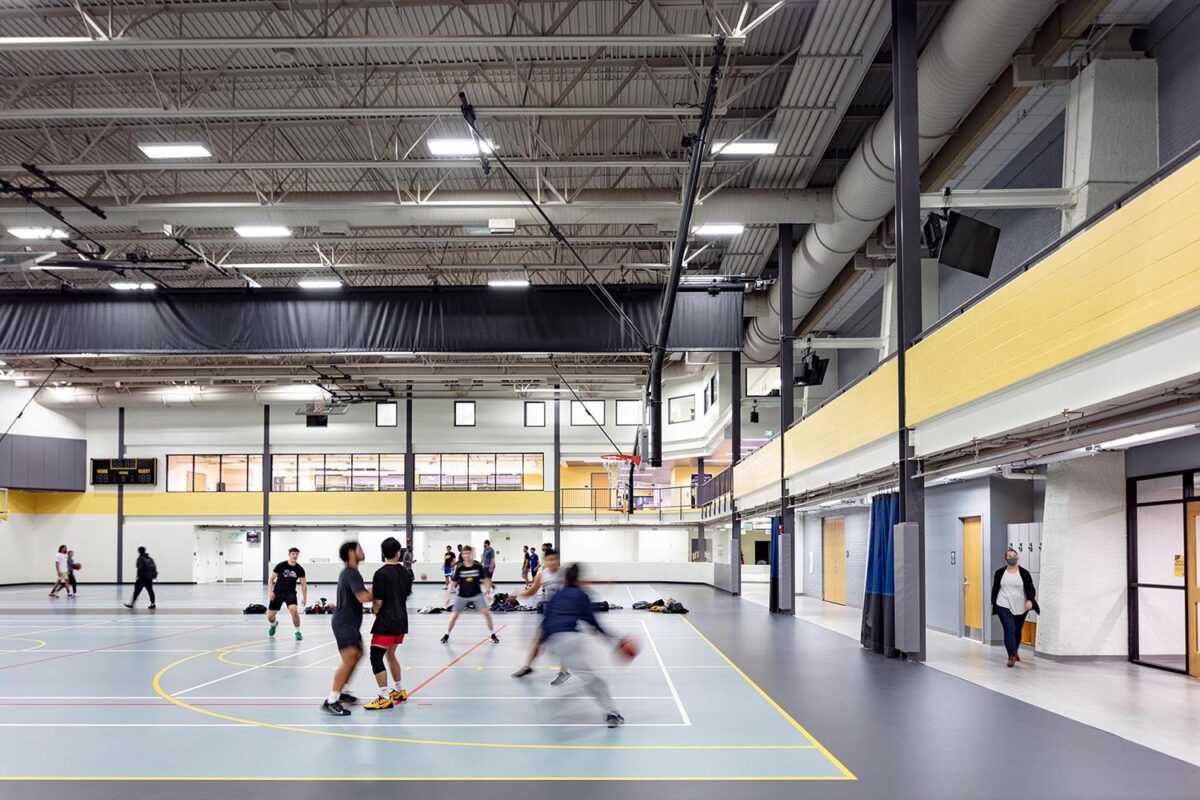 A motion-shot of people playing basketball in the refurbished RAC.