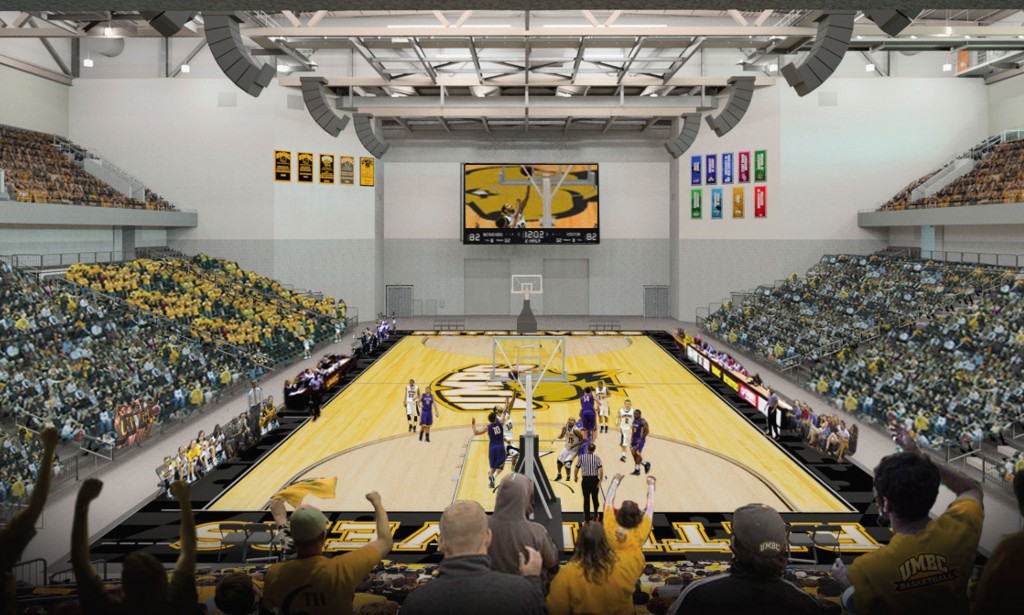 A basketball game is about to start at UMBC's new event center, and a large crowd of fans wearing black and gold are raising their arms and cheering.