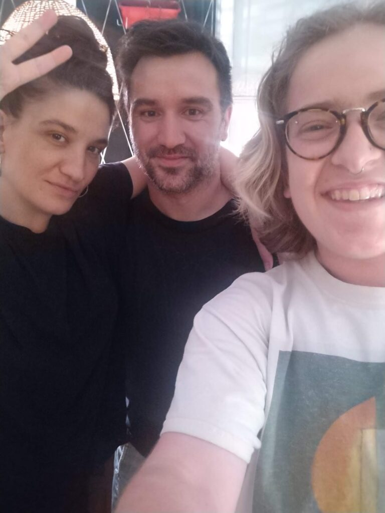 Boy smiles for a selfie with another two individuals while in Argentina studying language.