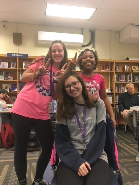 Group shot of Kaitlynn Lilly and two middle school students inside Arbutus Middle School.