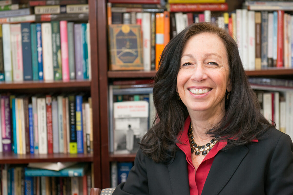 Portrait of Fulbright recipient Nancy Young in red shirt, black suit jacket, and black/gold necklace.