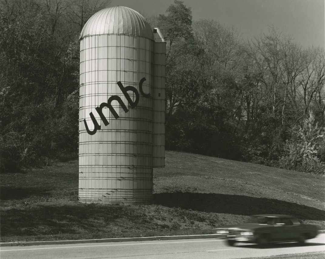 a farm silo with the word "umbc" written on it