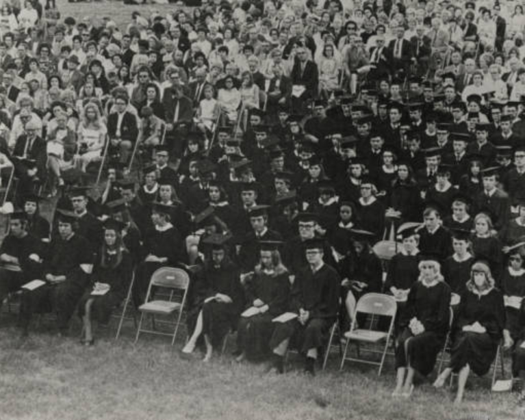 a black and white photo of an outdoor 1966 graduation event