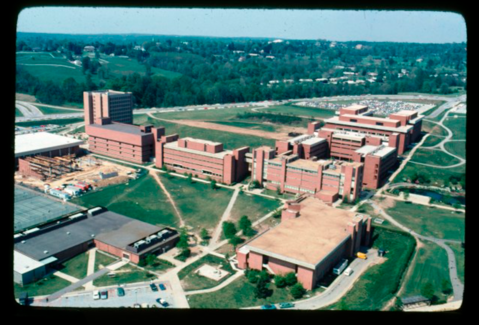 an overhead view of a campus with brick buildings and green grass