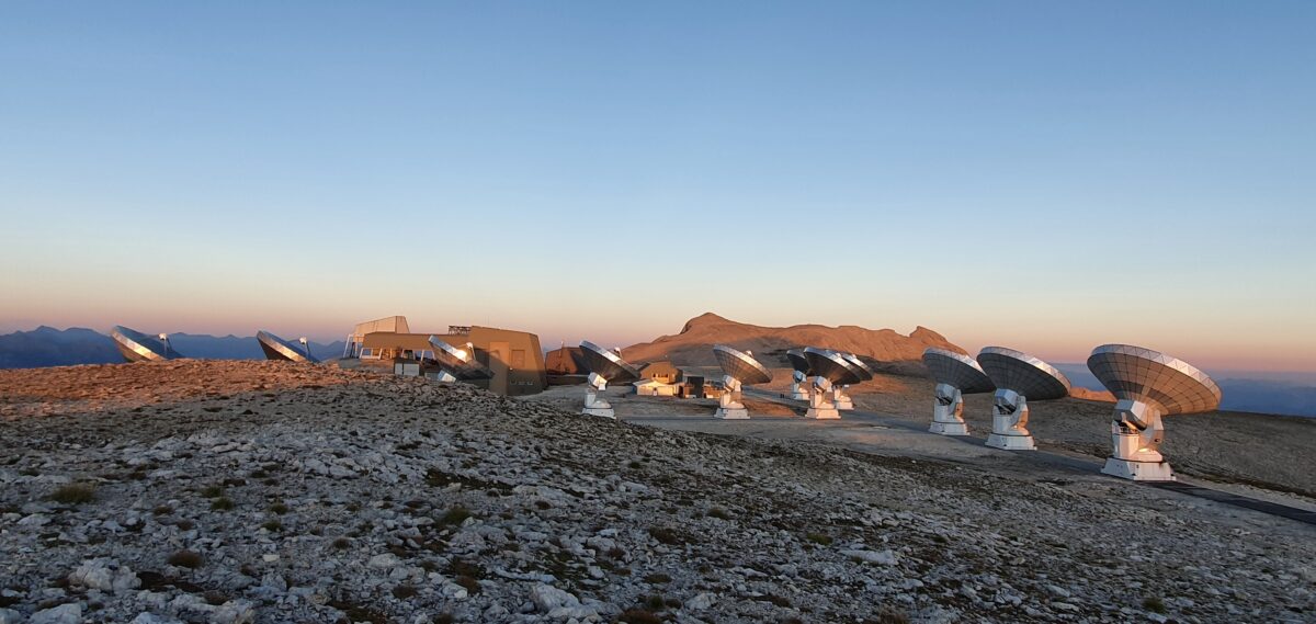 several large dish antennae on a rocky landscape