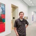 Man stands in front of artwork