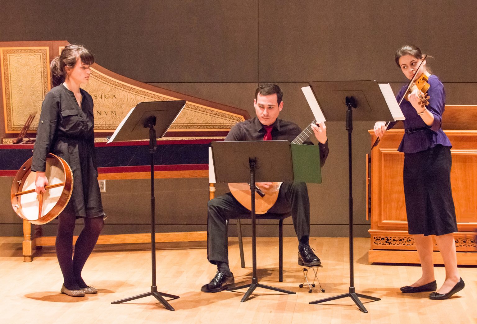 A group of three musicians with instruments