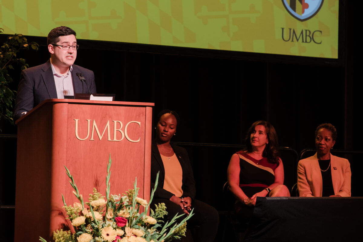 Male student speaking at UMBC podium