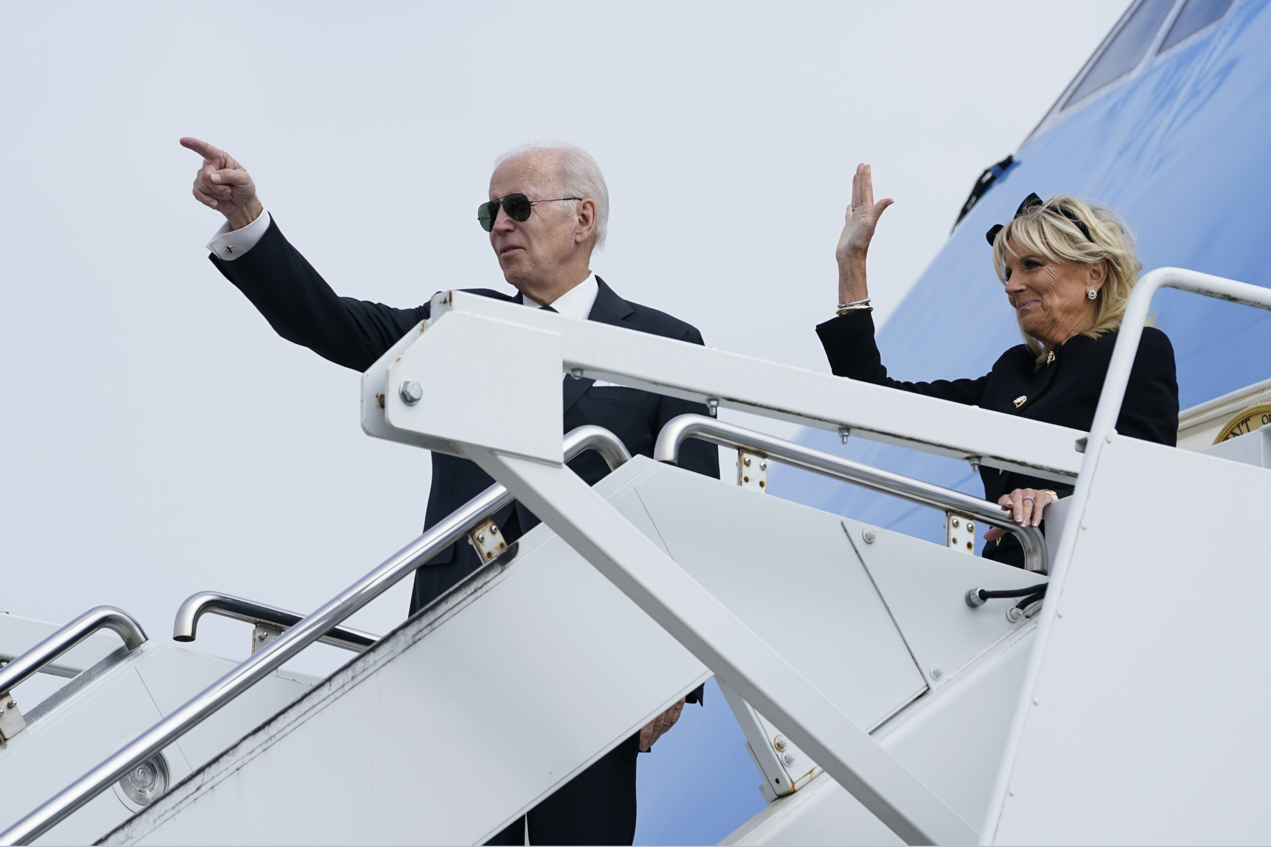 President Joe Biden and first lady Jill Biden wave before boarding Air Force One