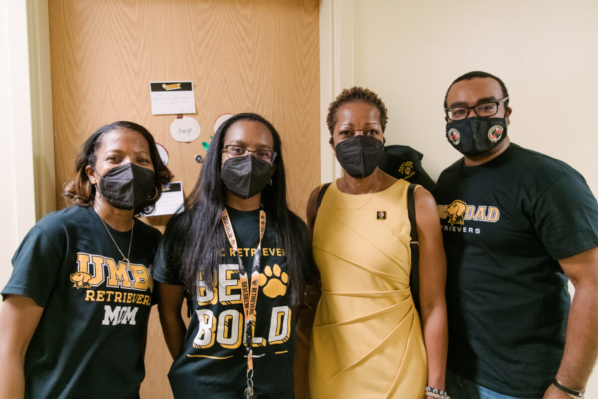 People in black and gray tshirts in front of student dorm room