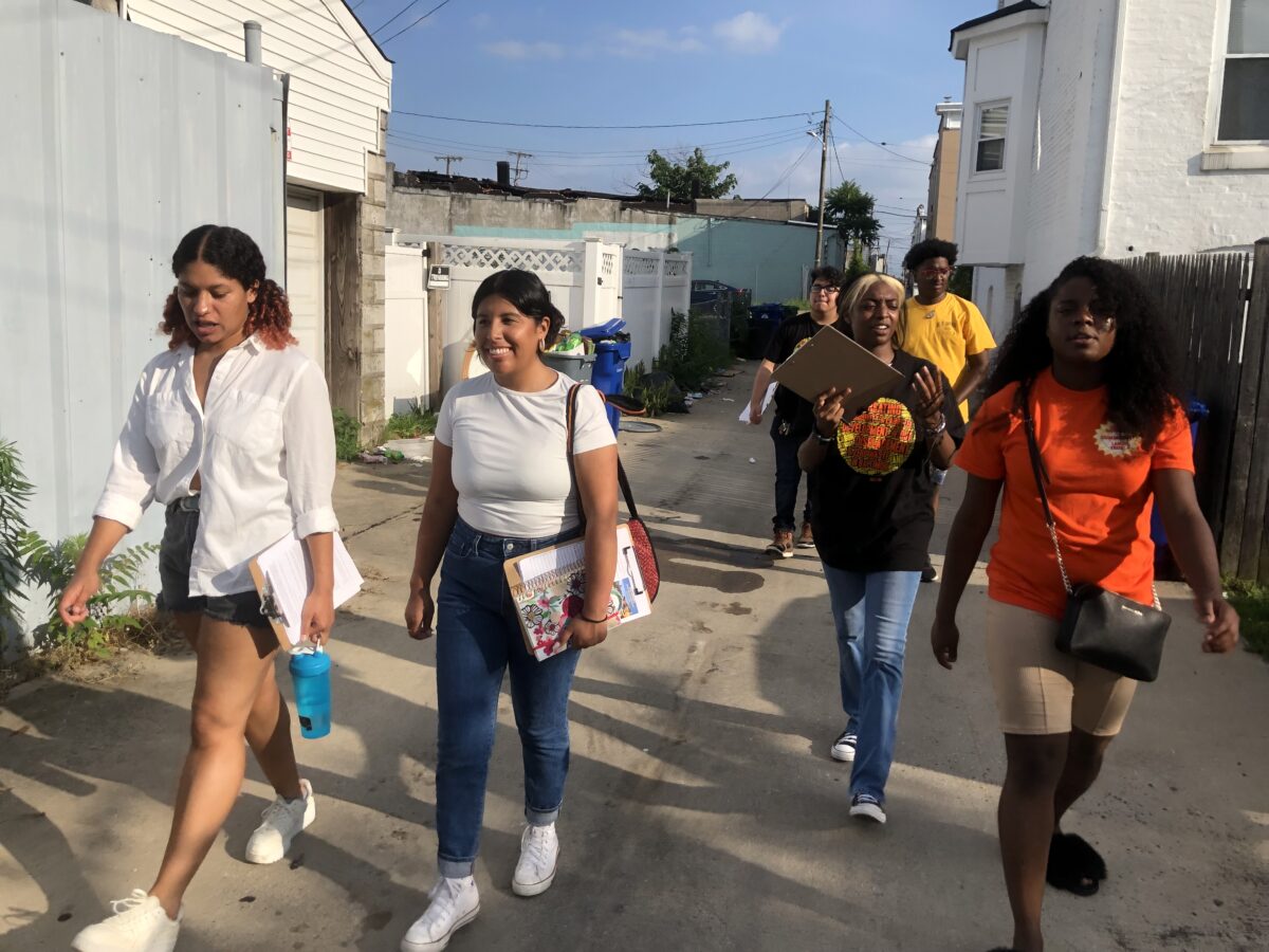 several people walking down a street in Baltimore