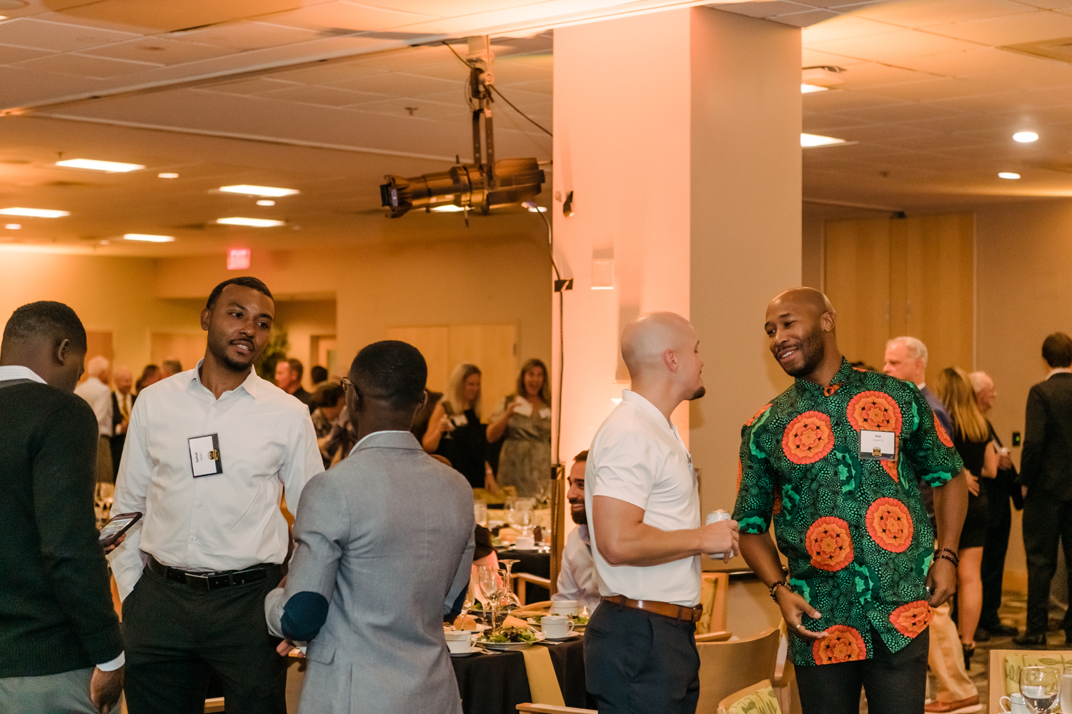 People make small talk at an event in the Skylight Lounge