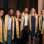 New 2022 Hall of Fame members pose together in gold stoles