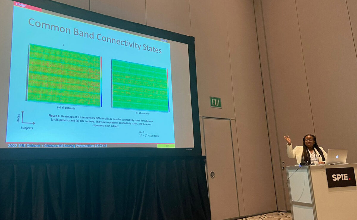 a woman gives a conference presentation about electrical engineering