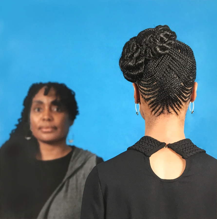Two Black women, the one of the left looking at the camera, the one on the right looking away