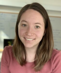 Headshot of smiling woman in rose-colored shirt