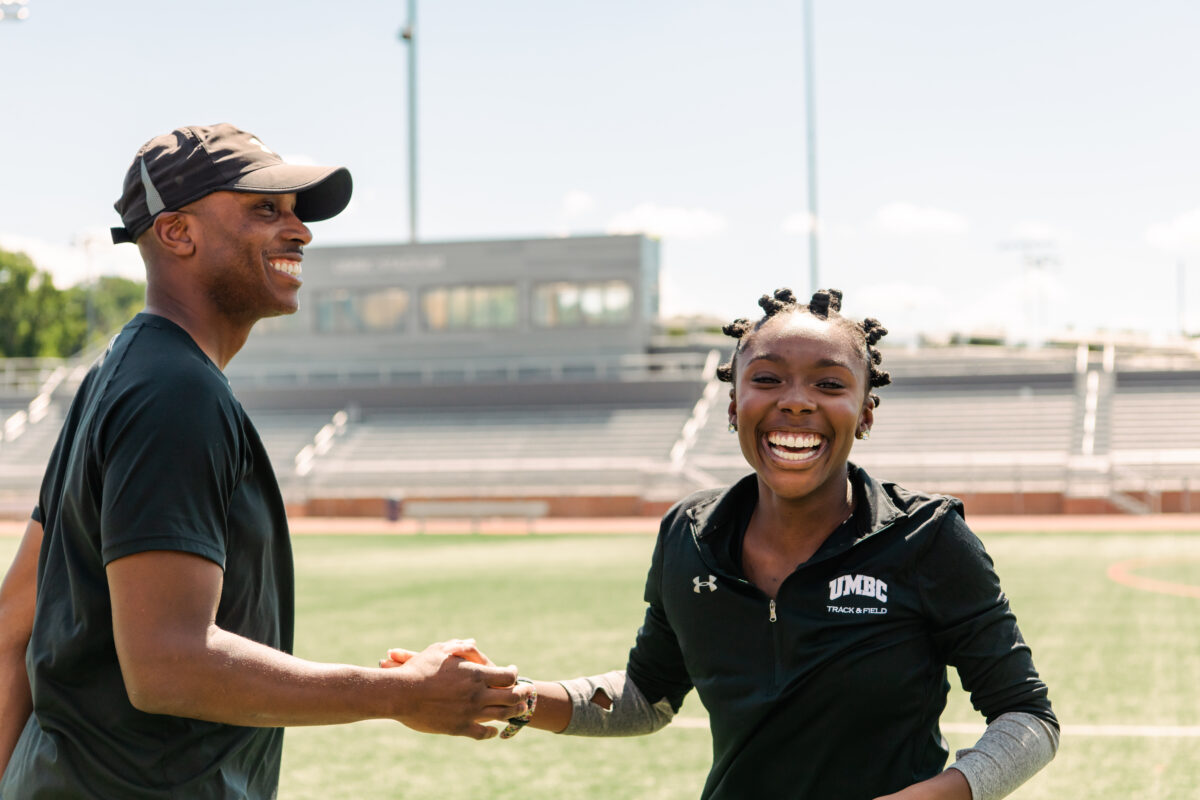 Coach David Bobb '97 and his daughter Caitlyn Bobb '24 smile on the track