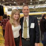 A woman and a man celebrate Retriever scholarships at UMBC