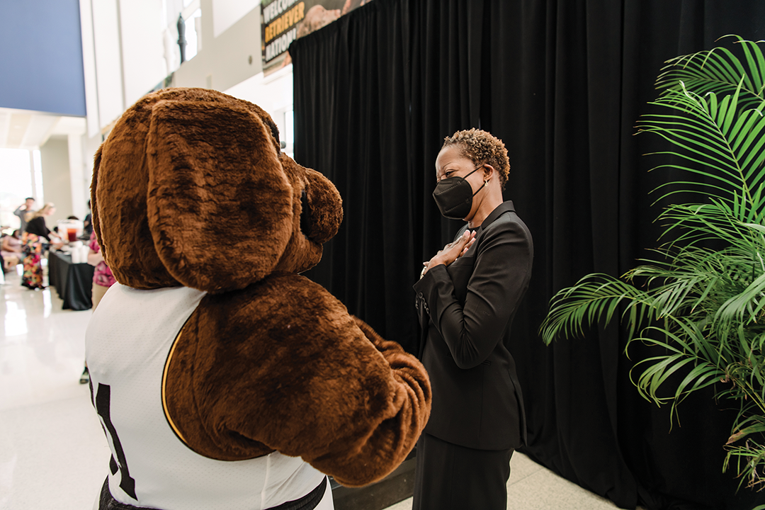 Mascot True Grit and President of UMBC meeting at an event.