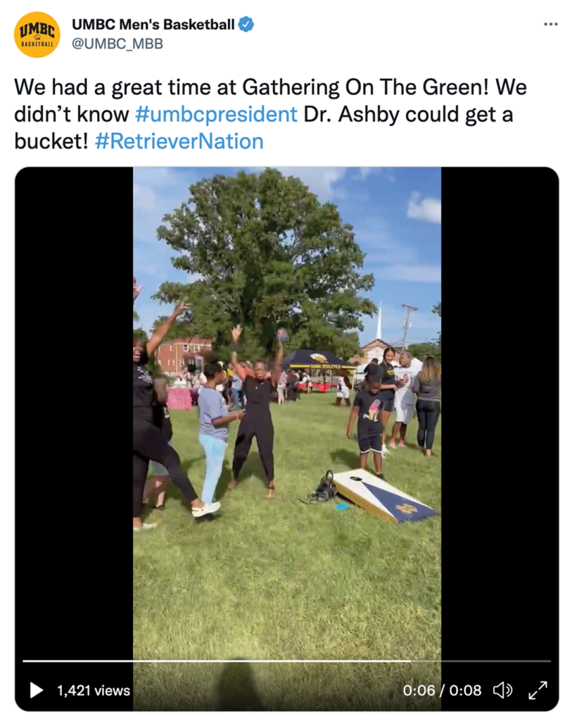 President of UMBC celebrating her win at a game of cornhole.