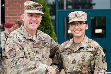 Two veterans wearing army camo gear.