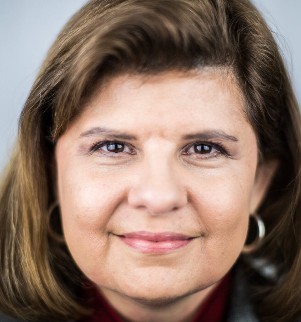 headshot of sandra abbott, a close up shot of her face frames by brown hair