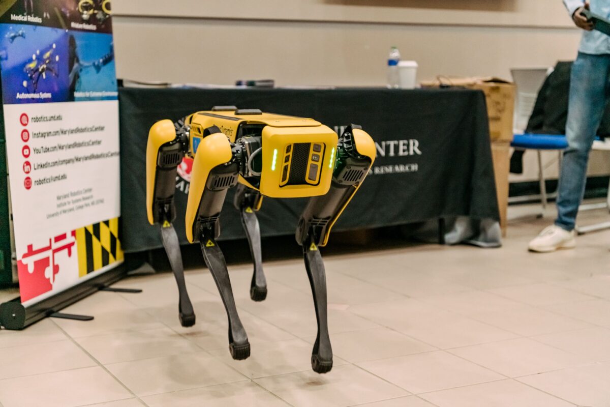 A four-legged robots jumps off the ground.