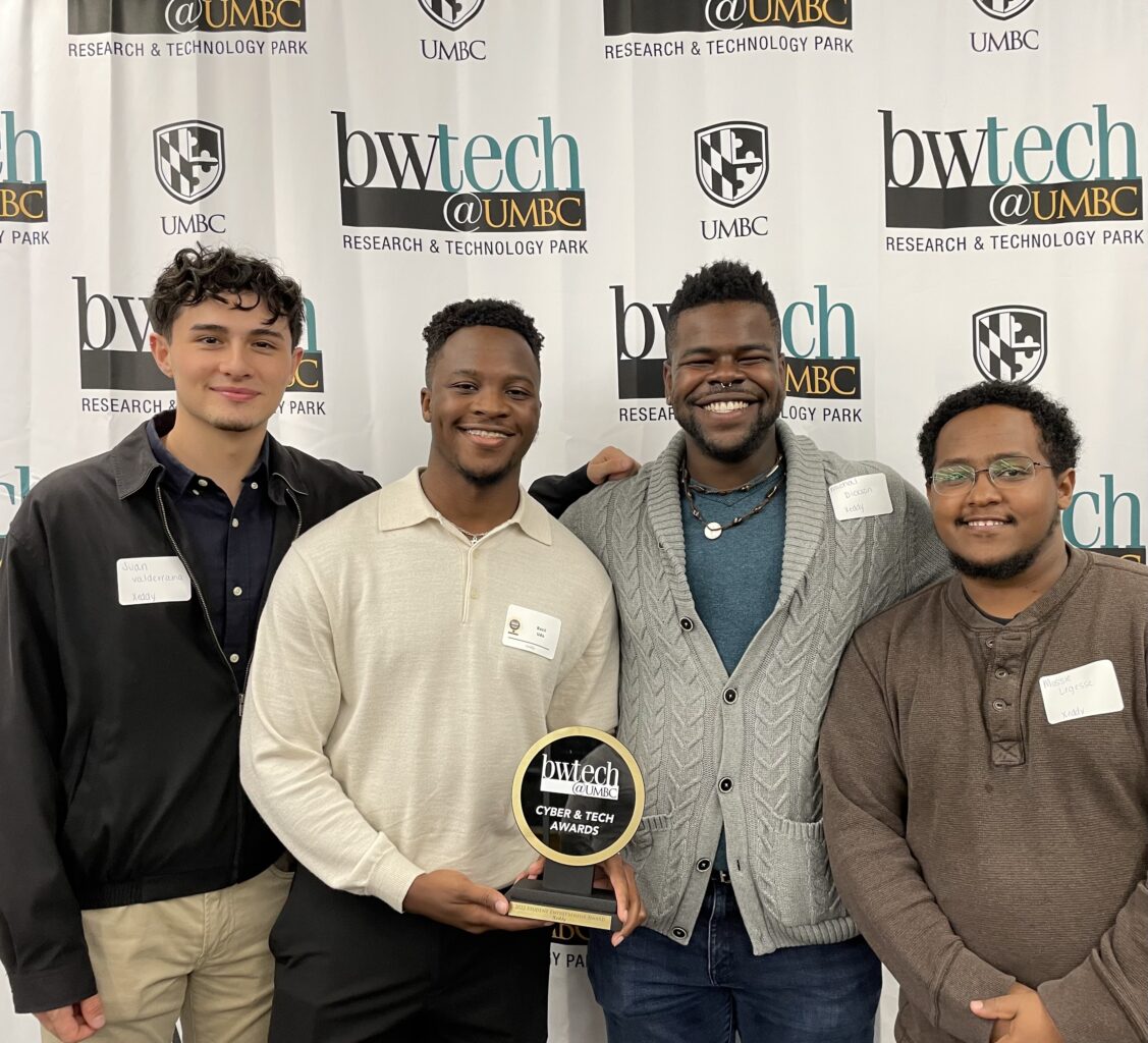 Four students receive an entrepreneurial award in front of a background that says bwtech
