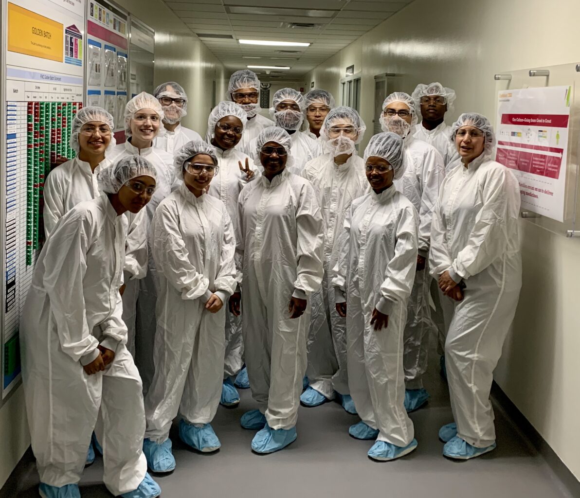 Students in lab gear at a biotech company