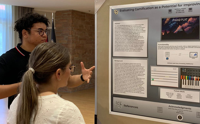 A young Latino man explains his research poster to a female student
