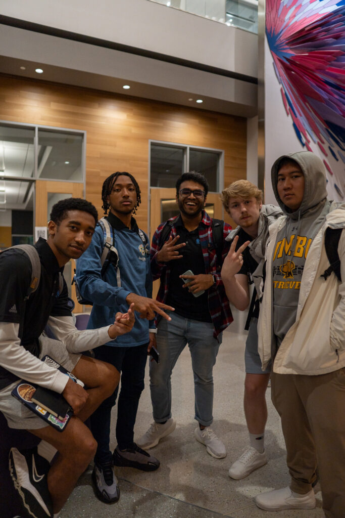 A group of students and scholar mentors pose together