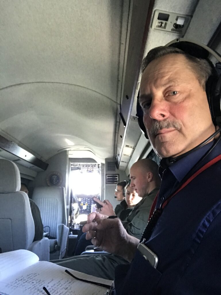 a man takes notes while inside a helicopter