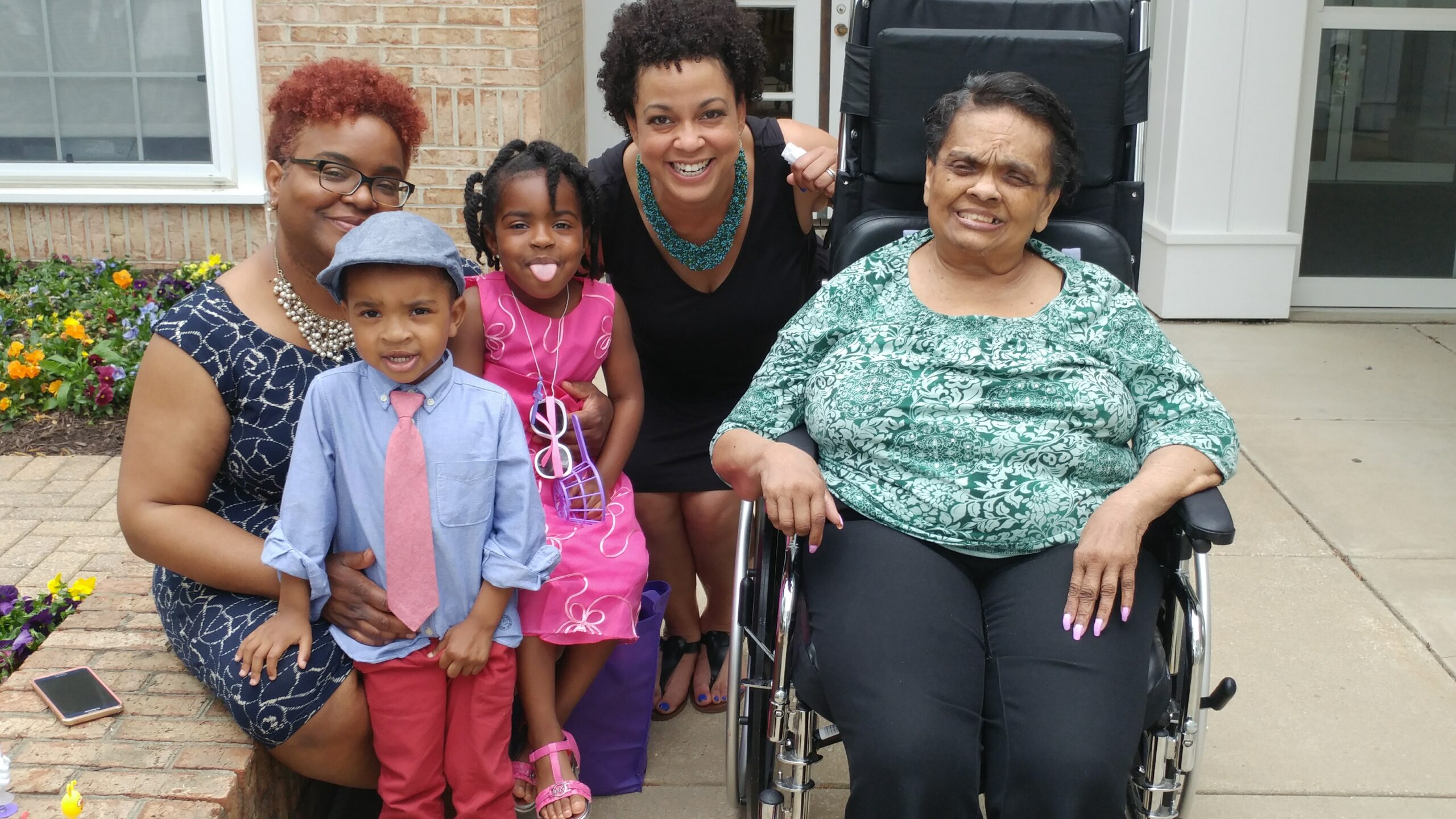 A family gathers around a matriarch in a wheelchair
