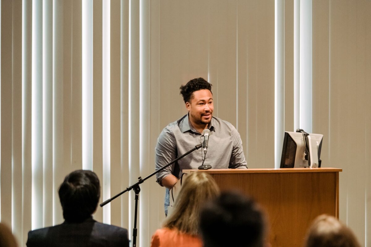 Speaker stands at podium at environmental science event