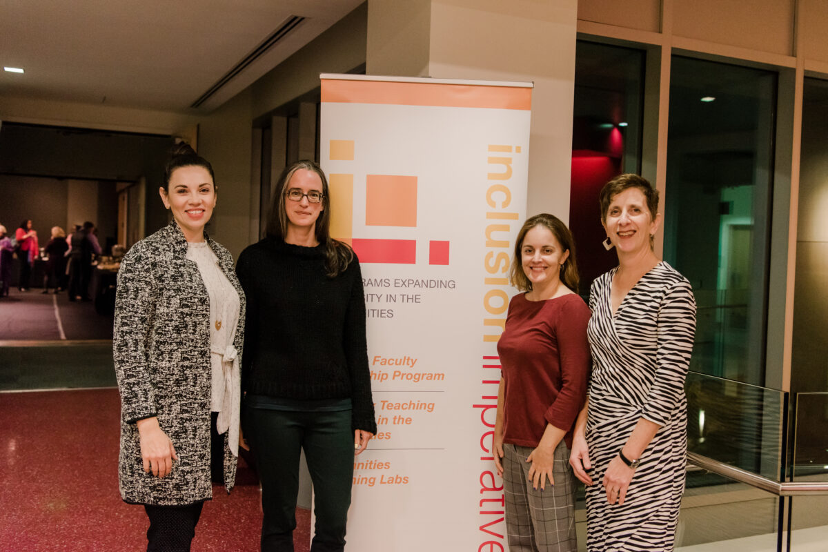 A group of four people stand on each side of a an Imperative Inclusion banner.