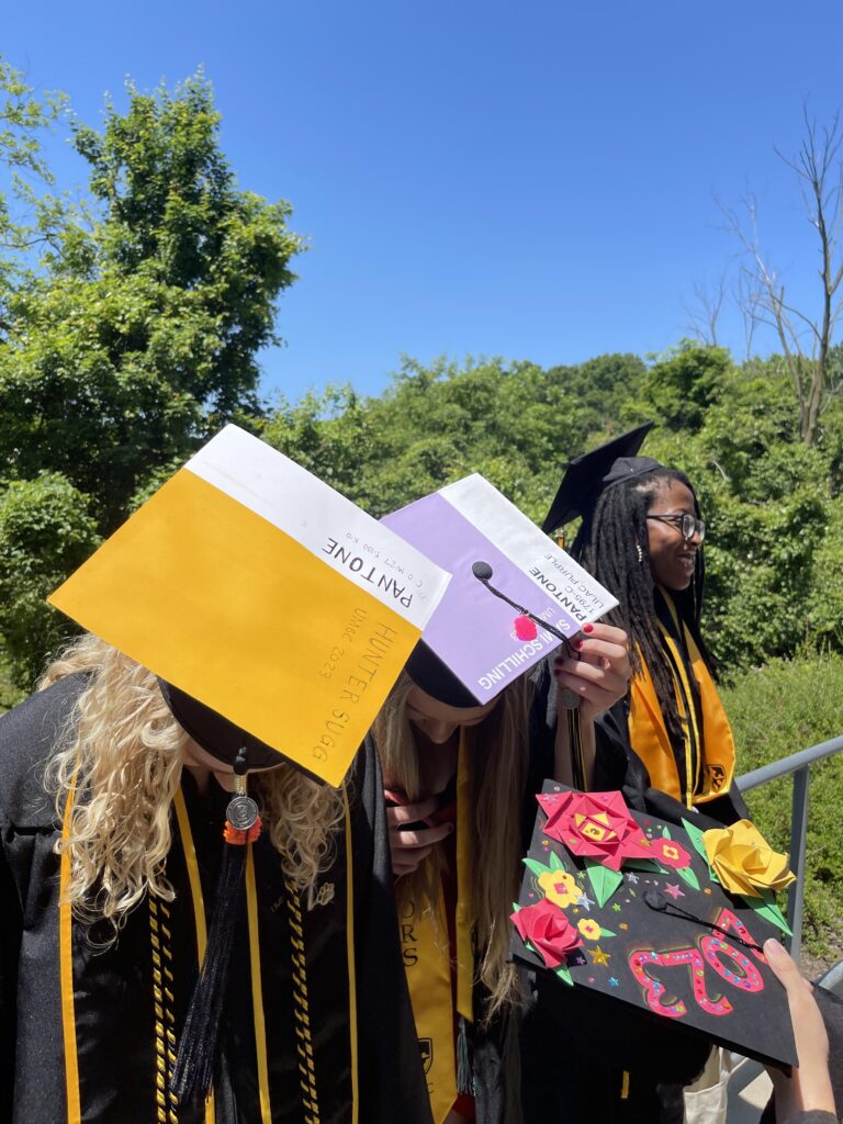 Graduating students display their decorated caps.