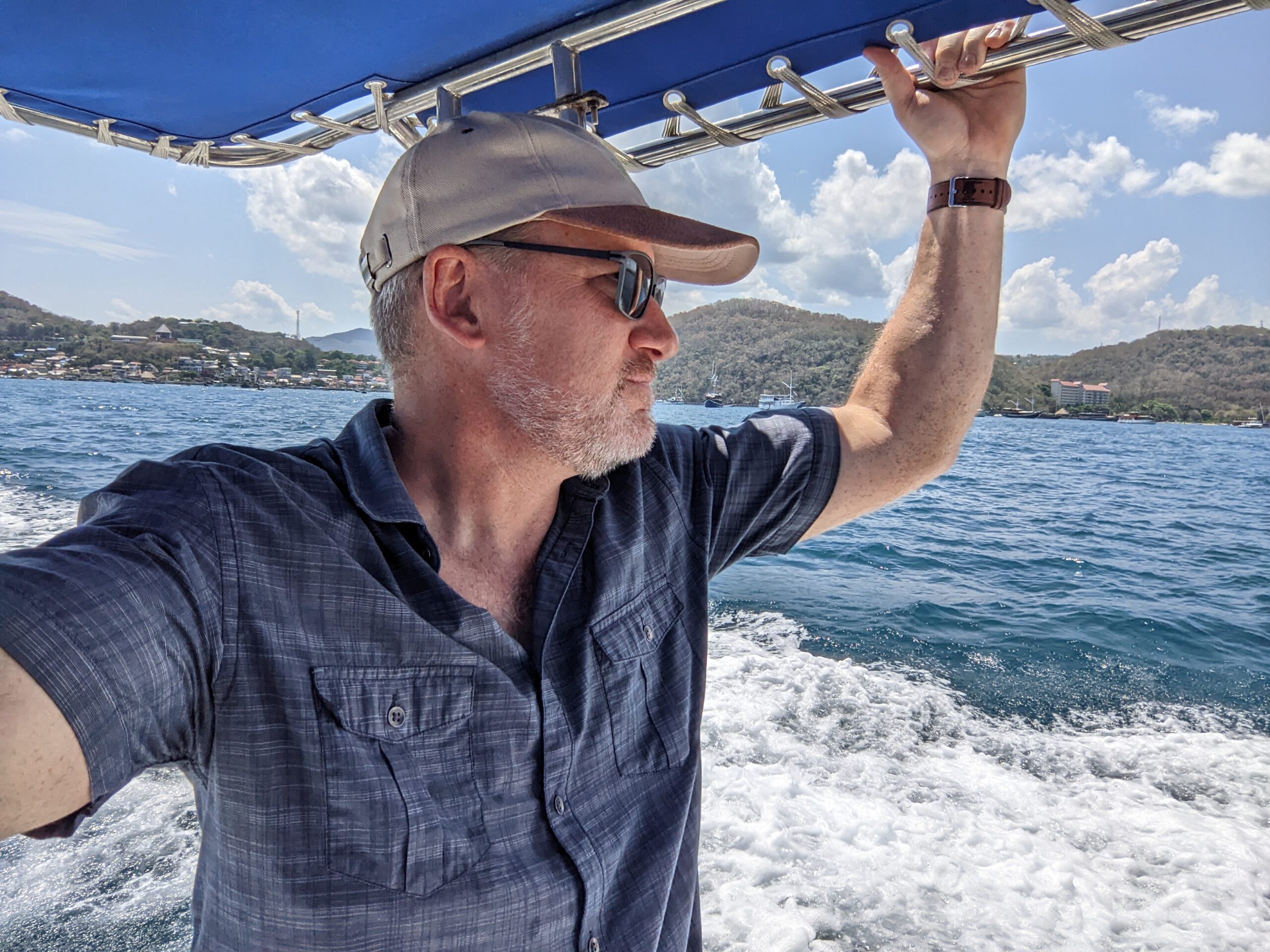 Terry Smith stands in a boat at sea working to change the effects of climate change on ocean life.