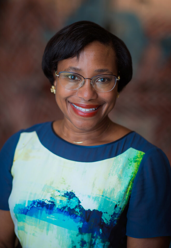 Paula Hammond smiling with glasses.