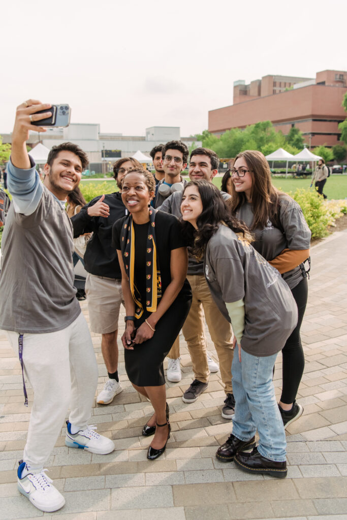 A group of students pose for a selfie with President Sheares Ashby at the celebration after her inauguration.