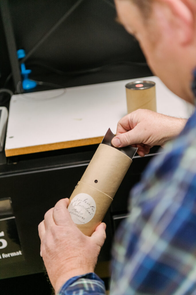 Peregoy handles a pinhole camera made of a packing tube