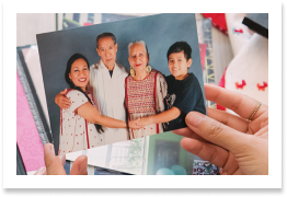 A hand holding out a portrait of a family