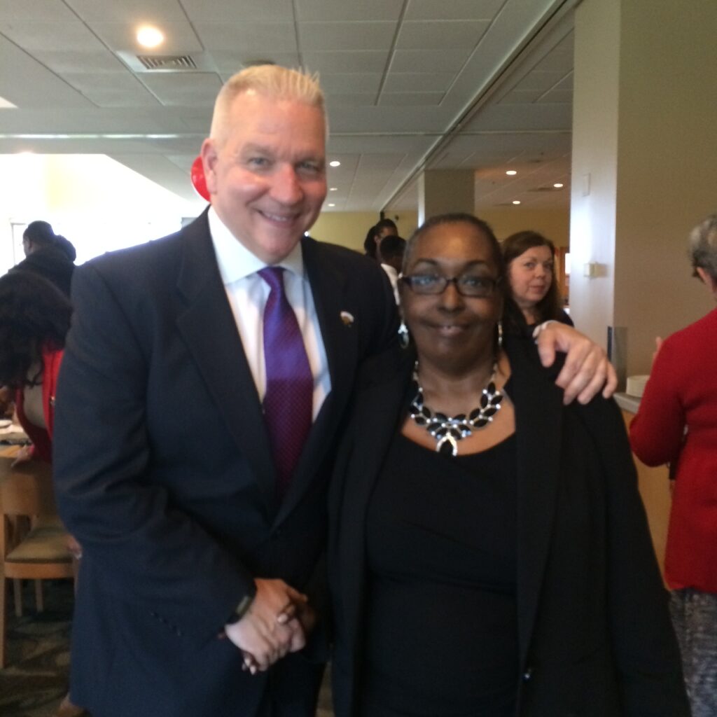 A man and a woman who work in advising at UMBC pose at an event