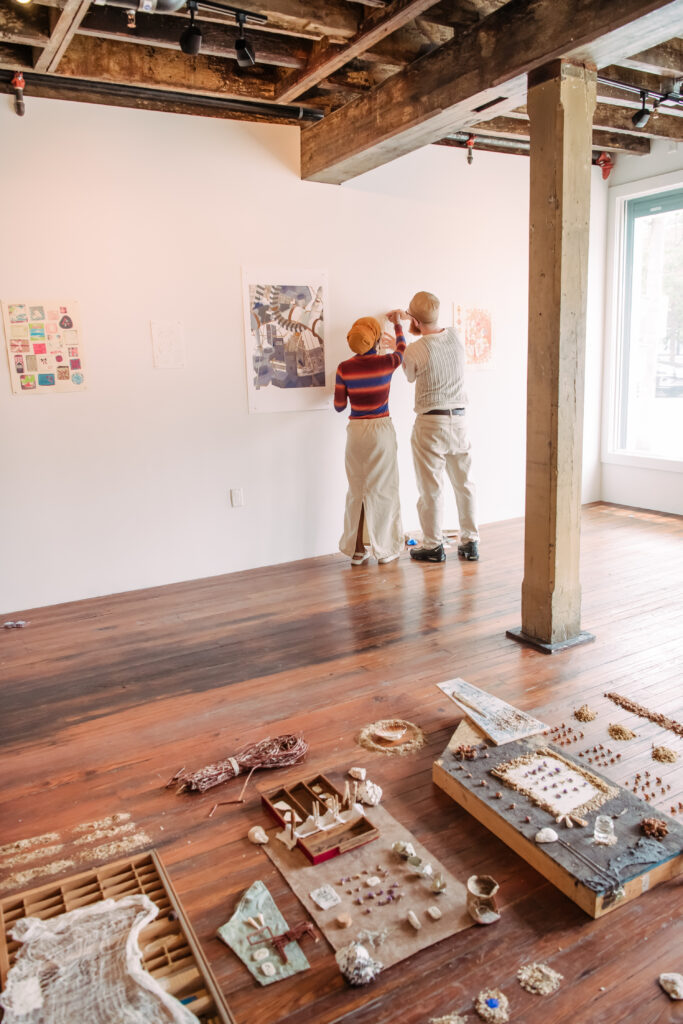 Cheatam, left, and Flounders put the finishing touches on their show. Photo by Marlayna Demond '10, for UMBC Magazine.